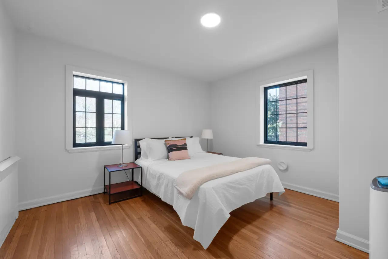 Historic apartment bedroom with restored original hardwood floors