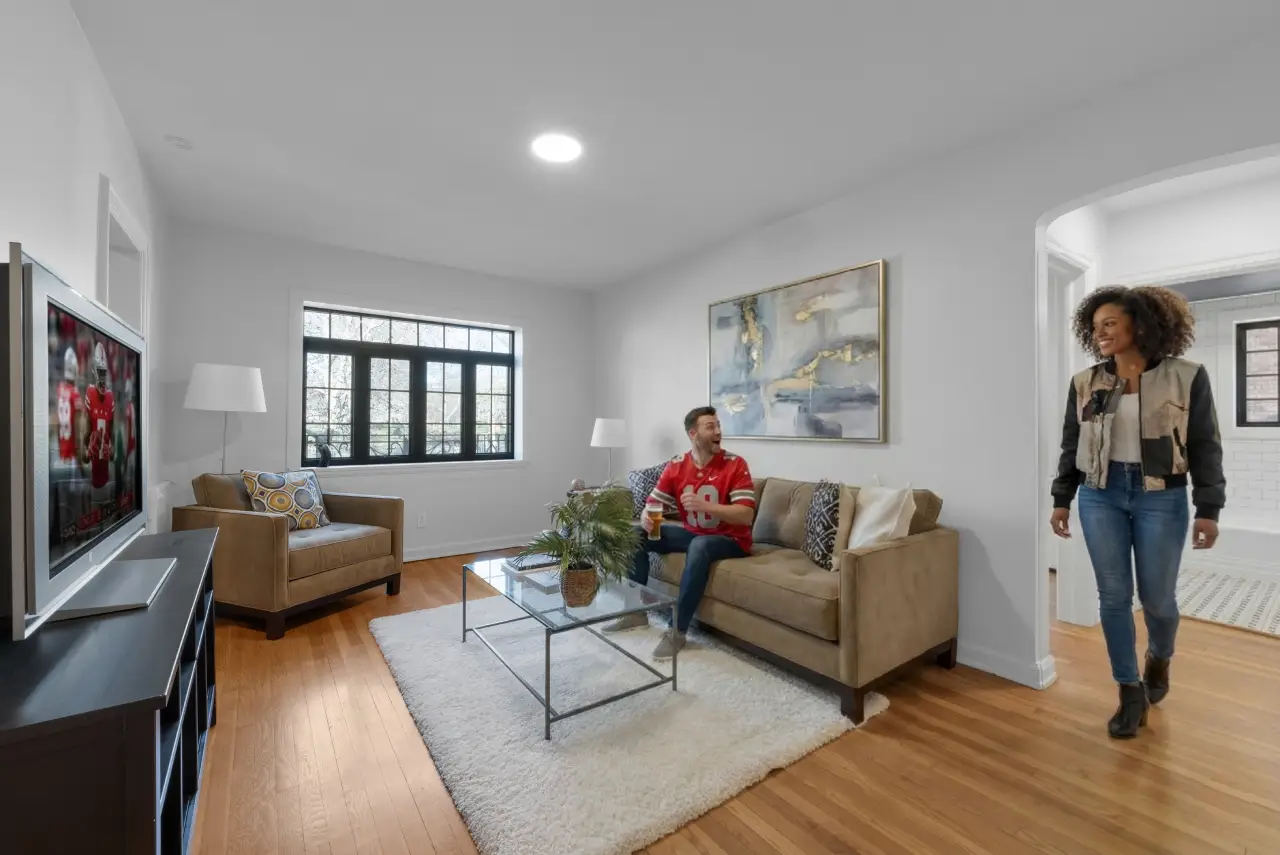 Spacious living room in historic downtown Columbus apartment with hardwood floors